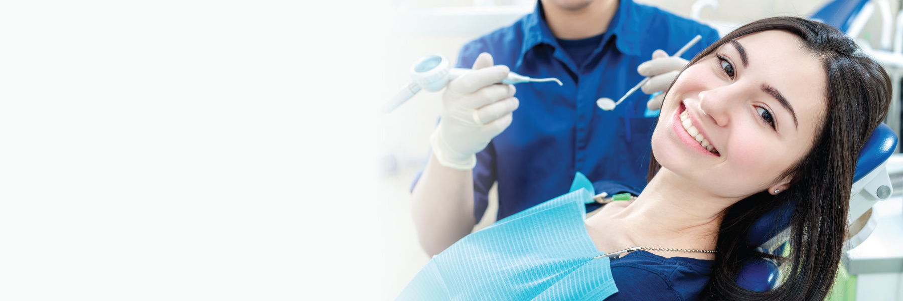 Smiling woman in dental chair during checkup to address medication-related gum changes