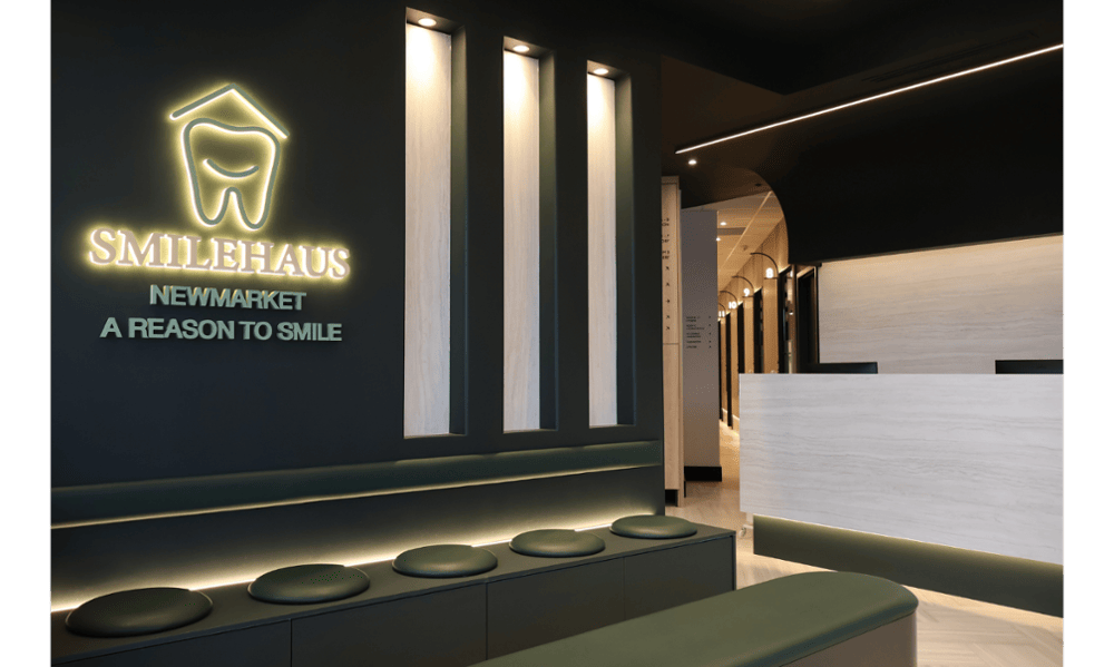 Comfortable waiting area with Smilehaus Newmarket wall logo and modern seating