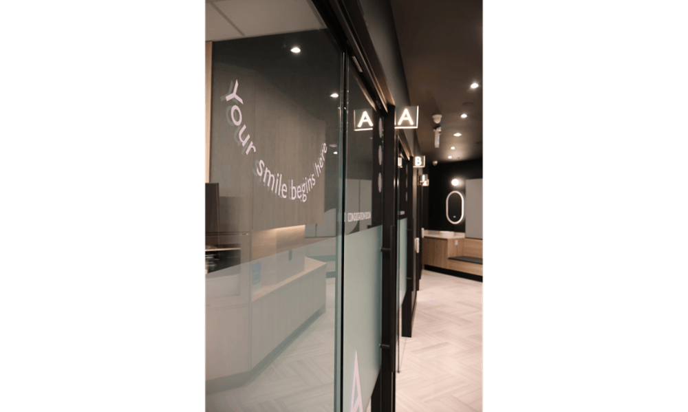 Consultation room hallway with glass doors at Smilehaus Newmarket
