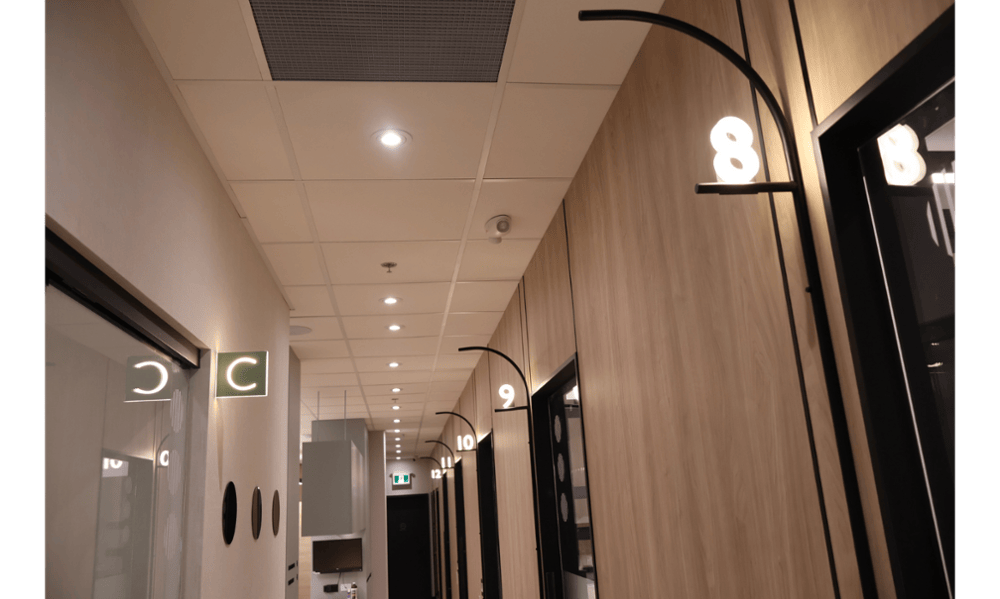 Hallway with hygiene room and treatment room signage at Smilehaus Newmarket