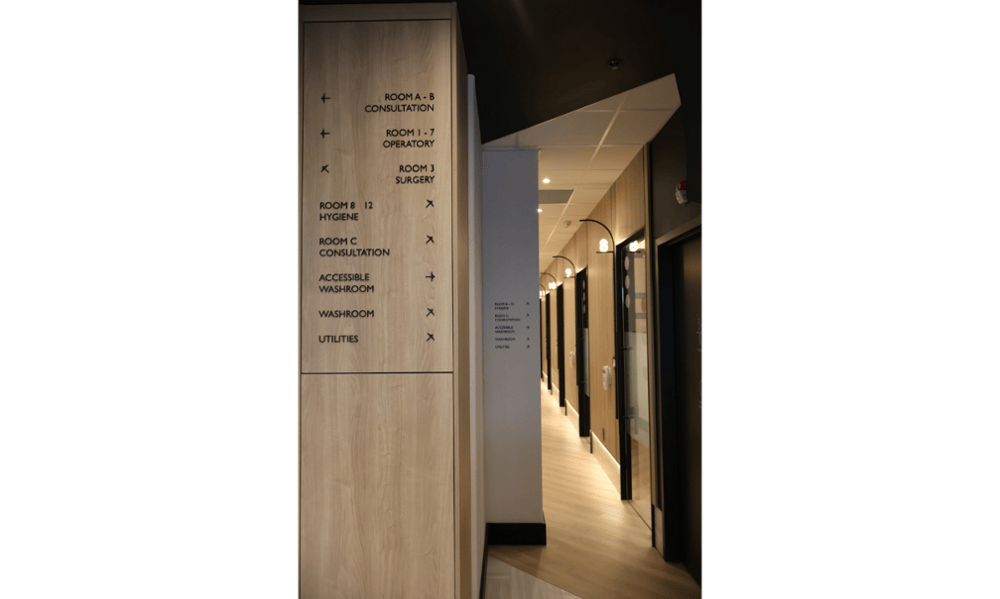 Room directory and hallway signage at Smilehaus Newmarket dental office