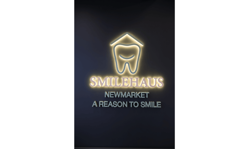 Illuminated Smilehaus Newmarket logo inside the dental clinic